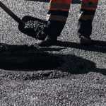 close up of workers and tarmac surface